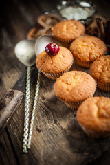 Muffins - sweet homemade cakes on a wooden kitchen table.