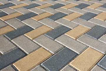 Background - colorful cobblestone pavement of the new paving stones. Diminishing perspective.
