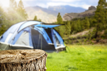 Desk of free space for your decoration. Blue tent on camping and landscape of mountains. 