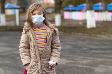 girl with white hair on her face a medical mask. She points a finger. Shallow depth of field