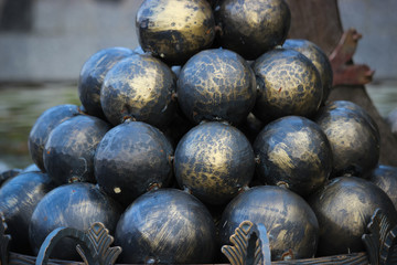 Conical black cannonballs forming an interesting pattern