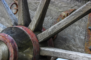Wooden wheel of an old cannon with wrought iron elements, close up