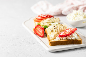 Strawberry banana goat cheese toasts. Selective focus, copy space.