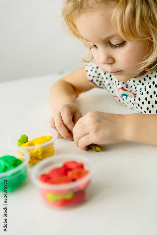 Wall mural the child is engaged in modeling on the table