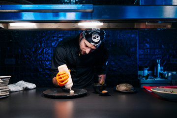 Chef preparing a dish in restaurant kitchen