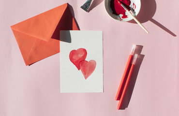 Making a Valetine's day card, red envelope and card with hearts