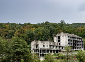 Fototapeta na wymiar Abandoned unfinished structure in mountainous terrain