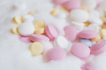 Obraz na płótnie Canvas colored pills background, antibiotic pills closeup
