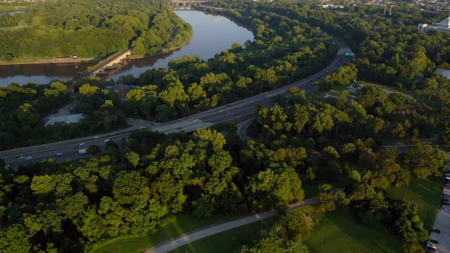 Aerial drone reveal of Philadelphia skyline and Schuylkill River with cars and traffic during a warm summer sunset
