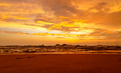 Fototapeta premium Dramatic sunset sky with red yellow clouds over ocean in Sri Lanka island