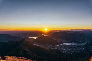 Naklejka na ściany i meble Sunset and landscape in the Orobie Alps during a fantastic cloudless day, near the town of Lecco, Italy - February 2019.
