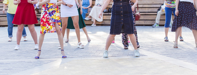 Social dance and flashmob concept - Fun and dance with in the summer on a city street. Close-up of...