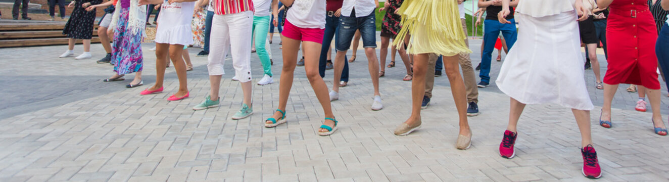 Social dance and flashmob concept - Fun and dance with in the summer on a city street. Close-up of dancers feet.