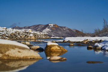Fototapeta premium Nature landscape with mountains, snowy cliffs and river.