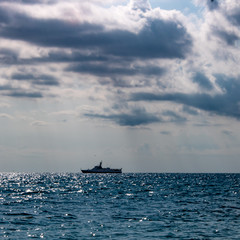 Fototapeta na wymiar Morning on the Black Sea in Sochi with clouds and ship on the horizon