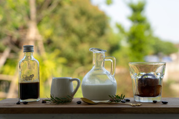 Set of Rich Americano coffee With side dishes in jugs, fresh milk and syrup for personal taste adjustment.