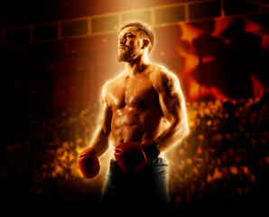 Boxer in red gloves on dark background