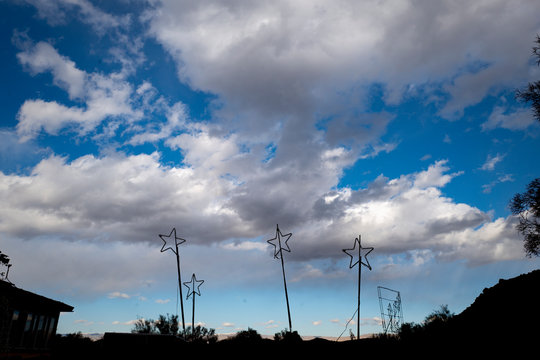 star lights on a hill in the day time with clouds