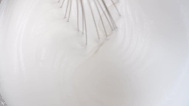 Closeup mix whipped protein cream using corolla for cake. Shot on RED Raven 4k Cinema Camera