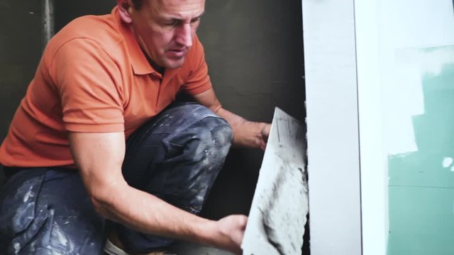  Fliesenleger bei der Arbeit, Renovierung eines Badezimmers 4k Video in zeitlupe