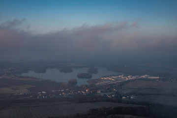 Sunrise time on Radobyl hill over valley of river Labe and Litomerice town