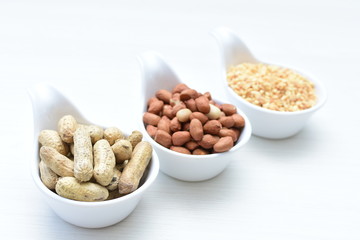 Dried peanuts (Arachis hypogaea) peanuts in shells, whole and chopped in containers