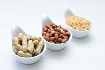 Dried peanuts (Arachis hypogaea) peanuts in shells, whole and chopped in containers