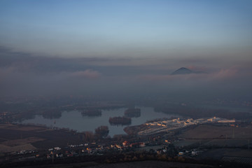 Sunrise time on Radobyl hill over valley of river Labe and Litomerice town