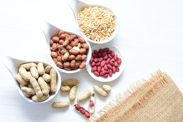 Fototapeta premium Dried peanuts (Arachis hypogaea) peanuts in shells, whole and chopped in containers