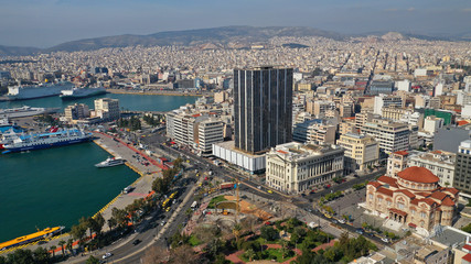 Obraz premium Aerial drone photo of abandoned old public landmark skyscraper in famous busy port of Piraeus, Attica, Greece