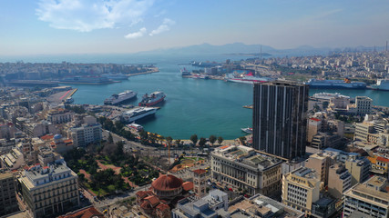 Fototapeta premium Aerial drone photo of abandoned old public landmark skyscraper in famous busy port of Piraeus, Attica, Greece