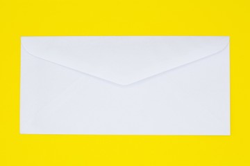 white envelope on yellow paper. - background.