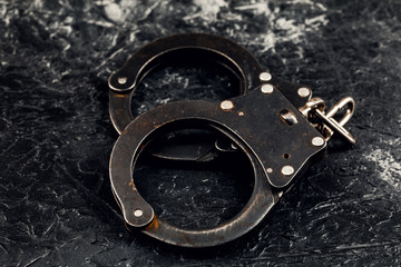 Handcuffs on a dark background. The concept of crime and police.