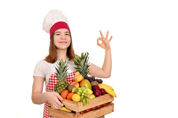 female cook with fruits in wooden crate and ok hand sign