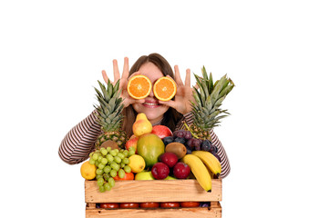 girl holding oranges in front of her eyes