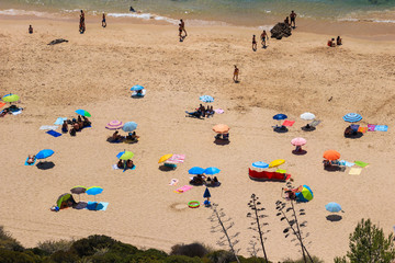 Fototapeta na wymiar Aerial view from a Tropical beach with colorful umbrellas.