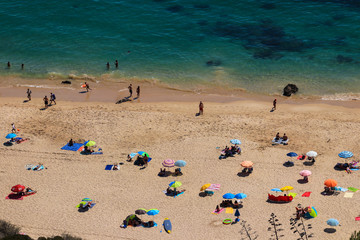 Fototapeta na wymiar Aerial view from a Tropical beach with colorful umbrellas.