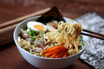Japanese ramen soup on wooden background. Selective focus