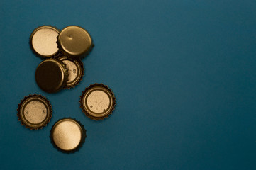 group of seven bottle caps on blue background