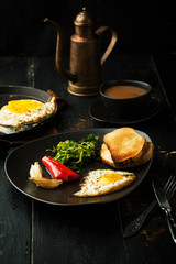 Breakfast. Fried eggs with vegetables and coffee with milk