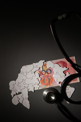 Chinese paper currency, world map and stethoscope 