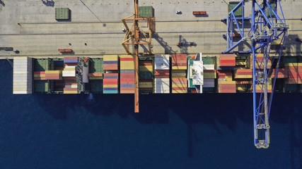 Aerial drone top down photo of industrial container logistics loading - unloading ship terminal in Mediterranean destination port