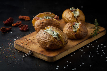 Baked potatoes with hamon and cheese