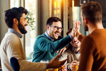 Group of friends enjoying in beer pub