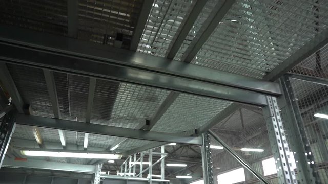 Metal gratings floor storey warehouse storage building structure look up view camera movement