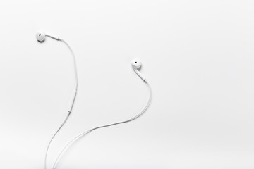 White modern headphones with a headset on a light gray background