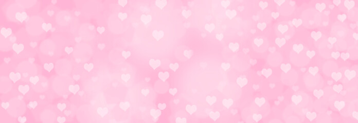 Abstract soft pink bokeh background - Romance or love concept - blurry bokeh circles with hearts on pastel pink background.