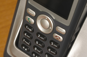 Keyboard of a gray push-button telephone close-up