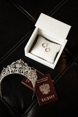 gold wedding rings in a box diadem and passports