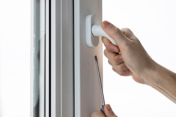 Handyman installing and repair the lock in front plastic door and window.